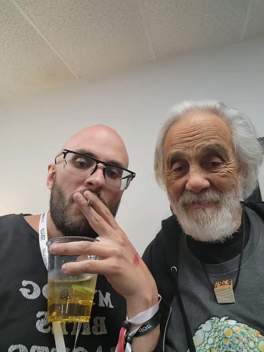 Jeremy Ryan beside Tommy Chong, holding a plastic cup.